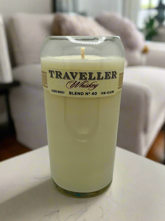 Upcycled whiskey bottle candle with creamy vanilla and bourbonwood scent in a reused Traveller whiskey glass container
