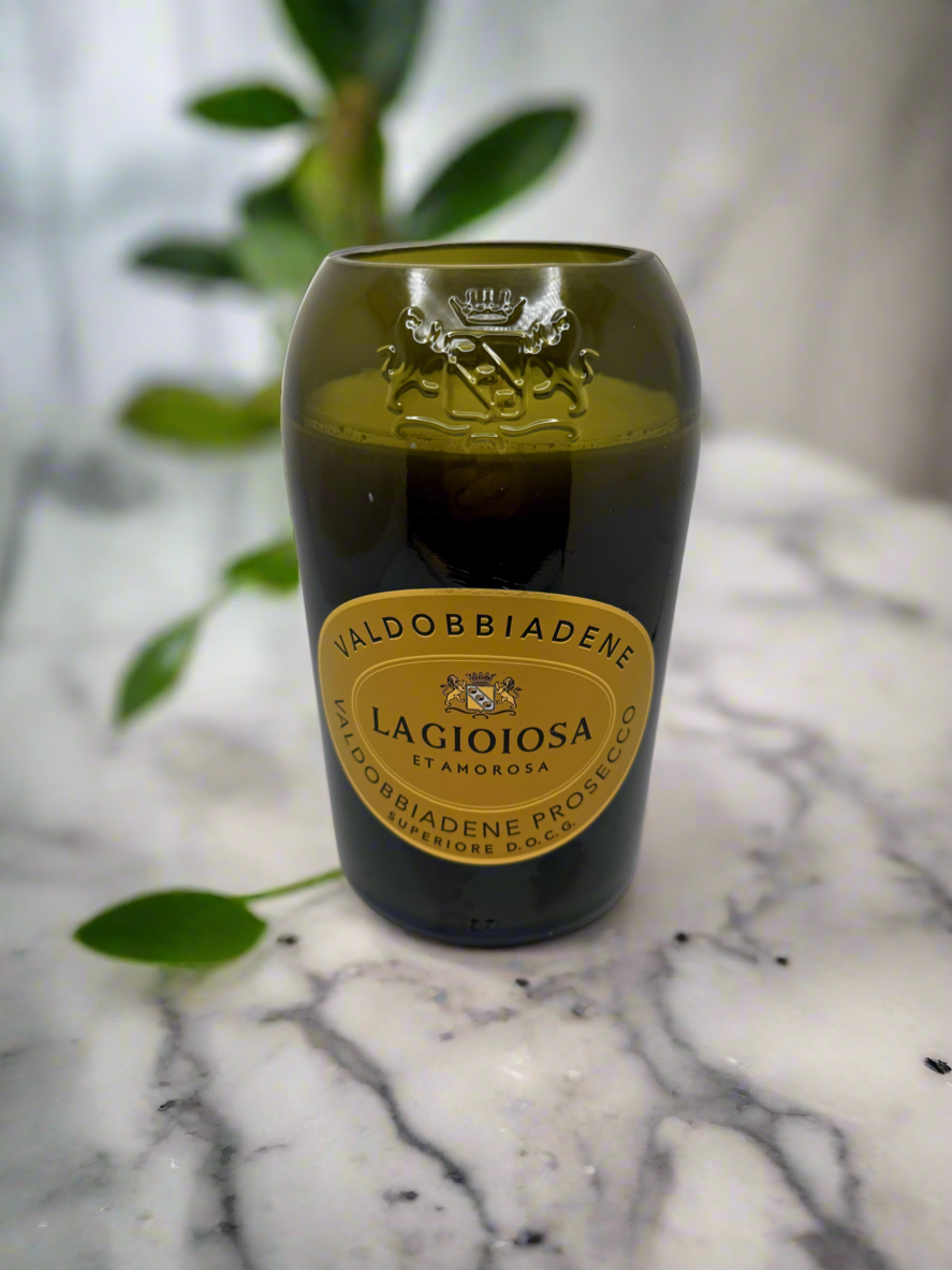 Upcycled wine bottle candle with pineapple sage fragrance on marble surface