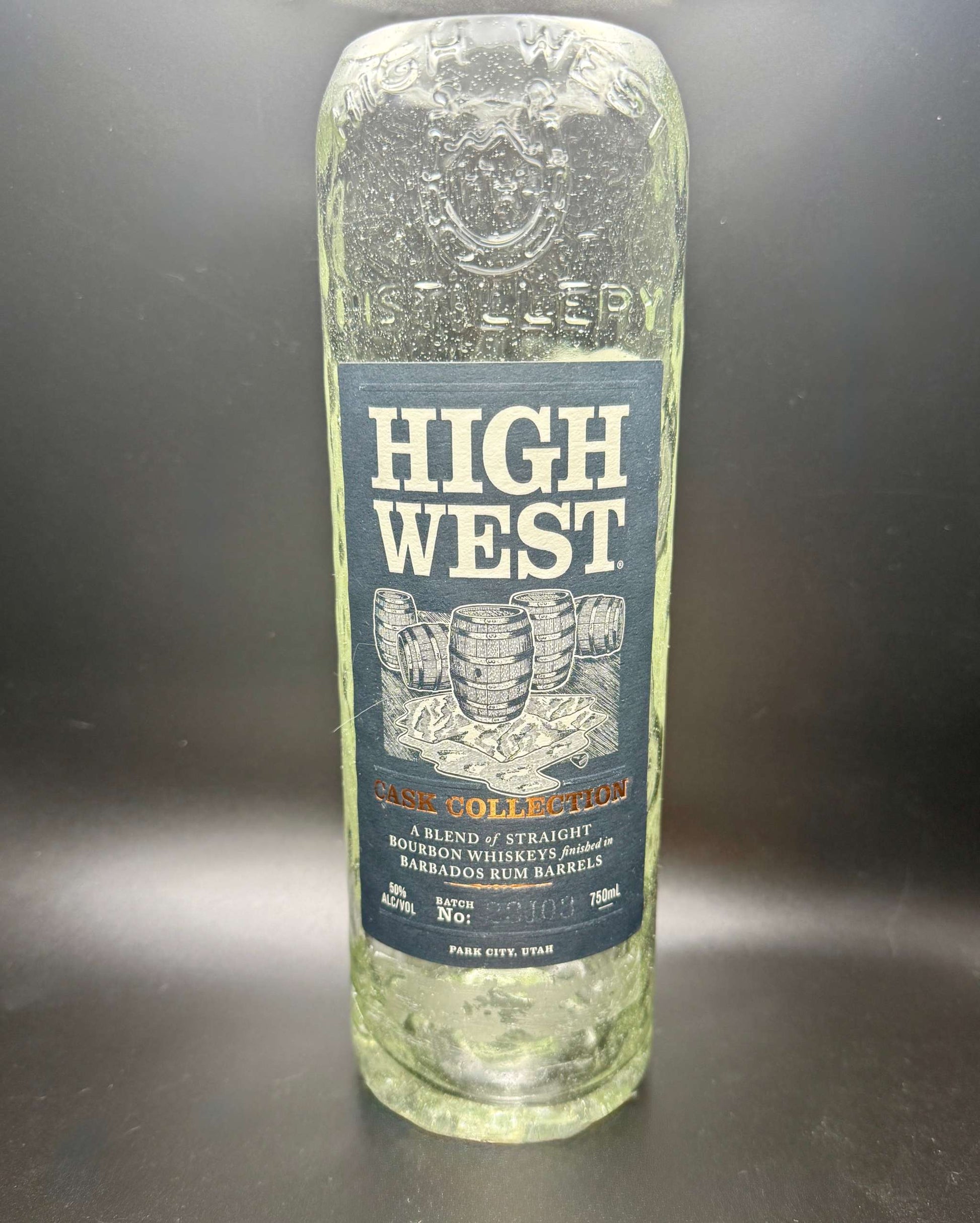 Clear empty whiskey bottle with High West label used for whiskey bottle candle creation