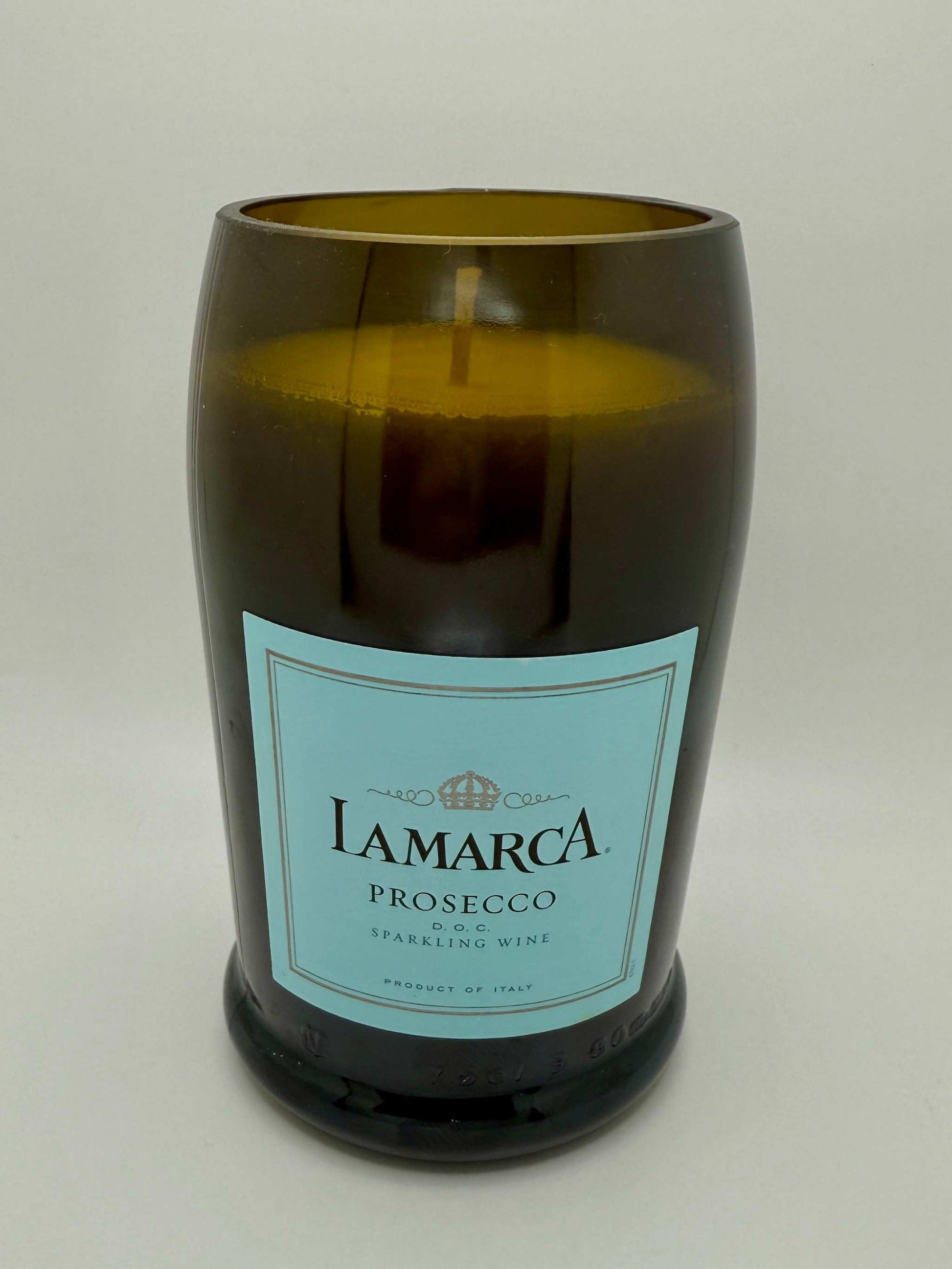 Upcycled wine bottle candle with white sage and lavender scent in dark glass container