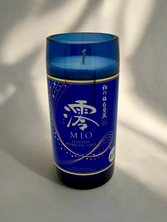 Blue upcycled sake bottle candle with Japanese sparkling sake label, Mediterranean Fig scent.