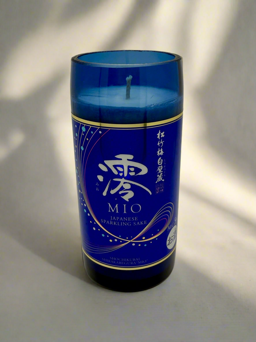 Blue upcycled sake bottle candle with Japanese sparkling sake label, Mediterranean Fig scent.
