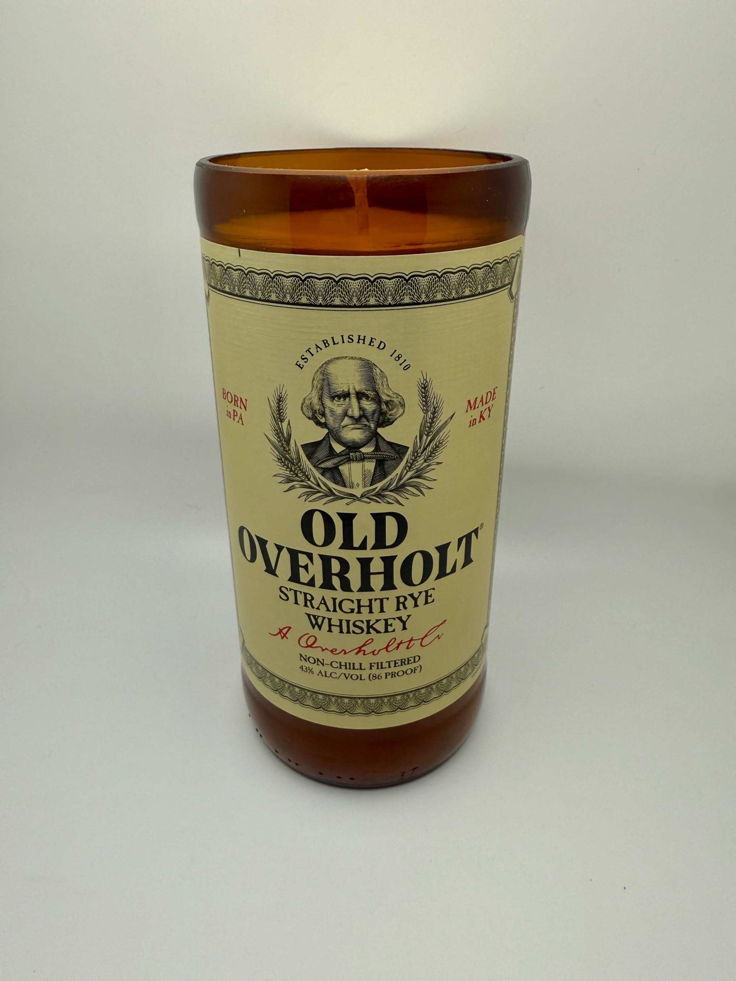 Upcycled whiskey bottle candle with Old Fashioned fragrance featuring bourbonwood, orange, and black cherry notes