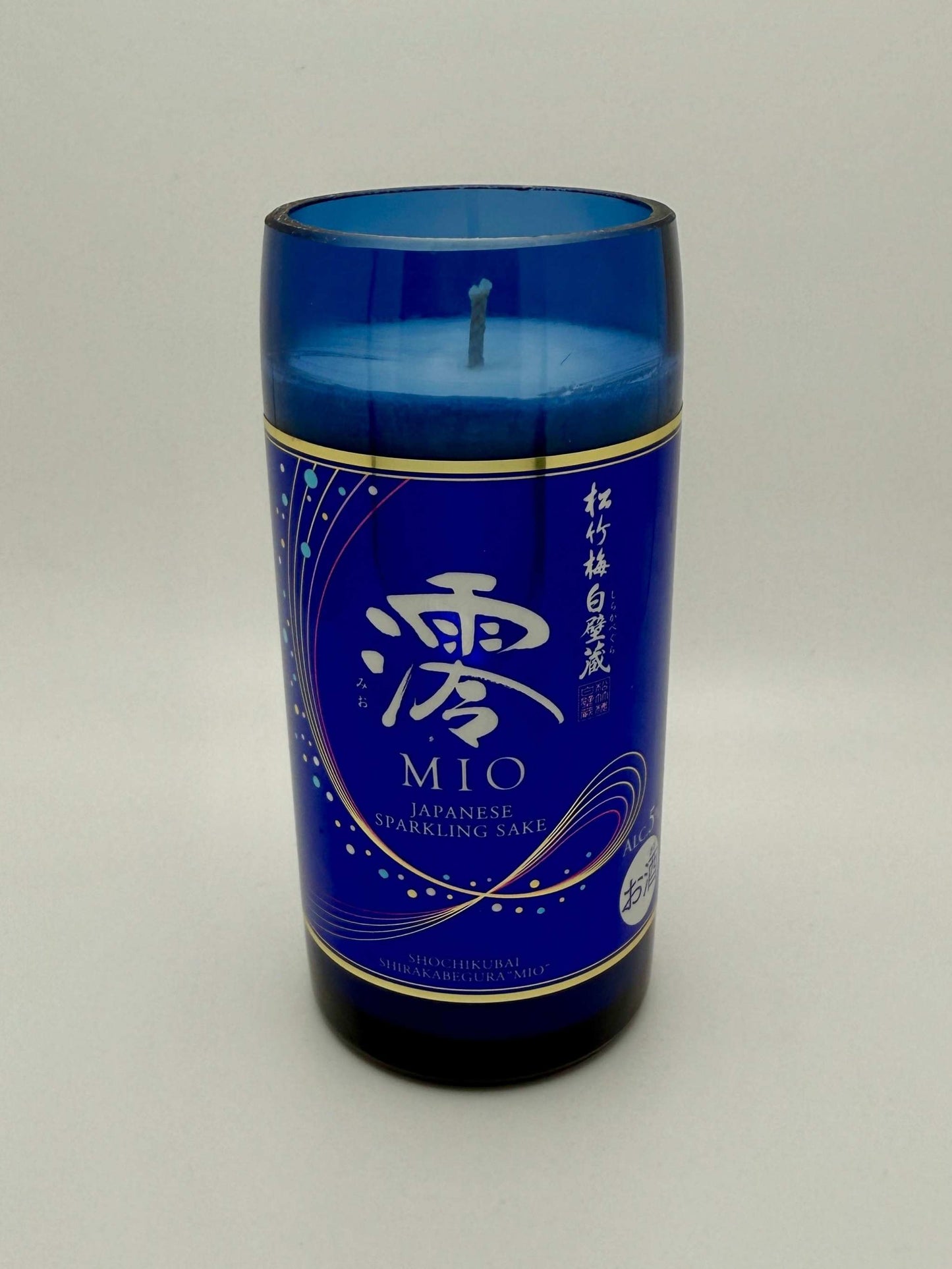 Upcycled sake bottle candle with Mediterranean Fig scent in blue glass container