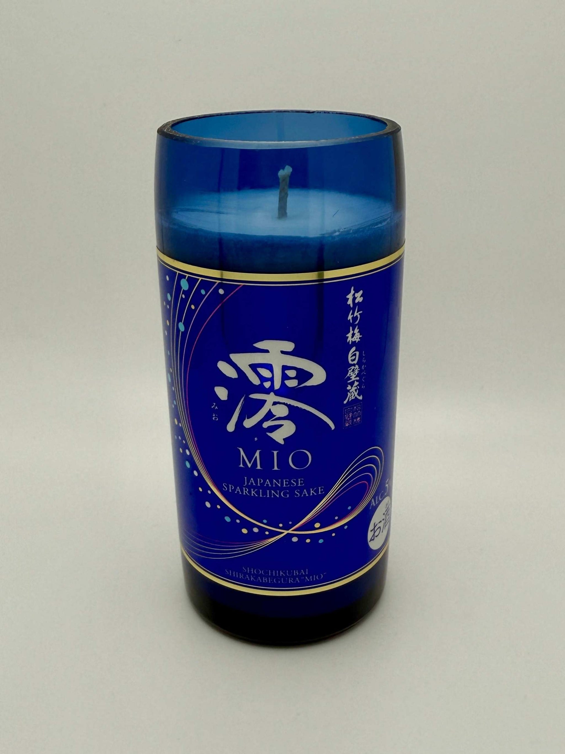 Upcycled sake bottle candle with Mediterranean Fig scent in blue glass container