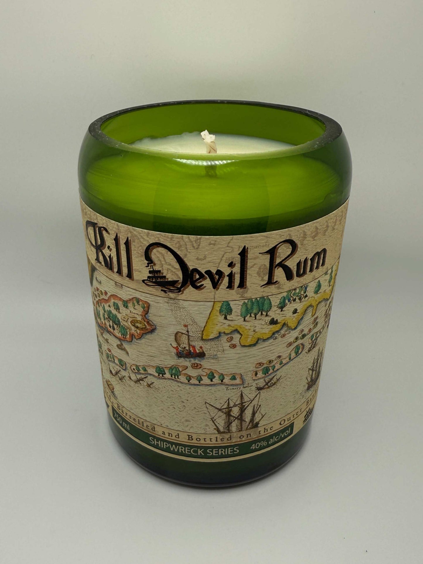 Upcycled rum bottle candle with Island Citrus scent in green glass container with vintage map label