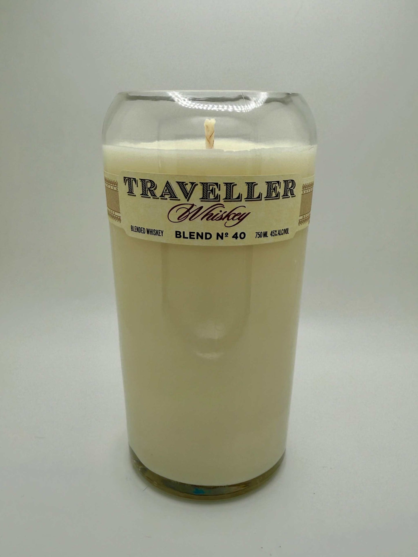 Upcycled whiskey bottle candle with warm bourbonwood scent in a repurposed Traveller Whiskey glass bottle