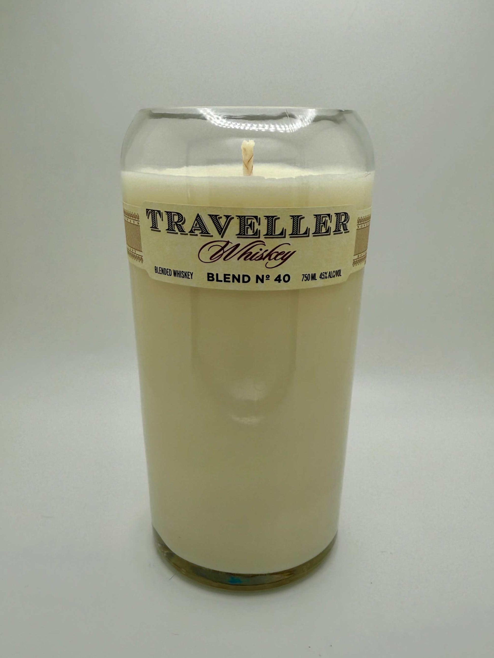 Upcycled whiskey bottle candle with warm bourbonwood scent in a repurposed Traveller Whiskey glass bottle