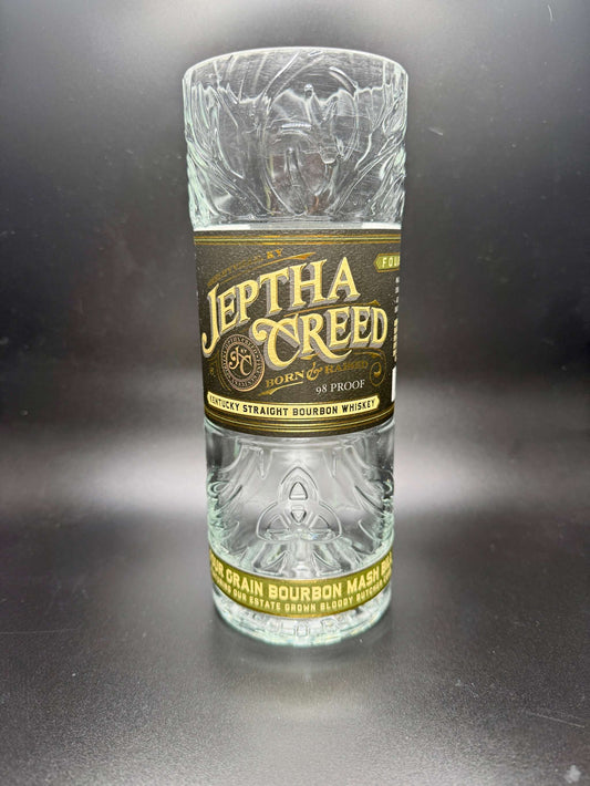 whiskey bottle candle in an upcycled Jeptha Creed bourbon whiskey bottle with custom soy wax filling