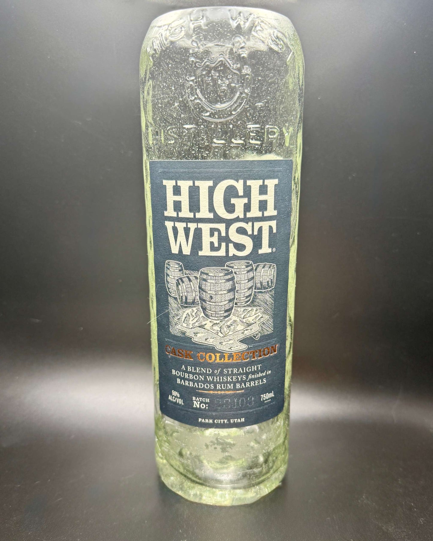 Clear empty whiskey bottle with High West label used for whiskey bottle candle creation