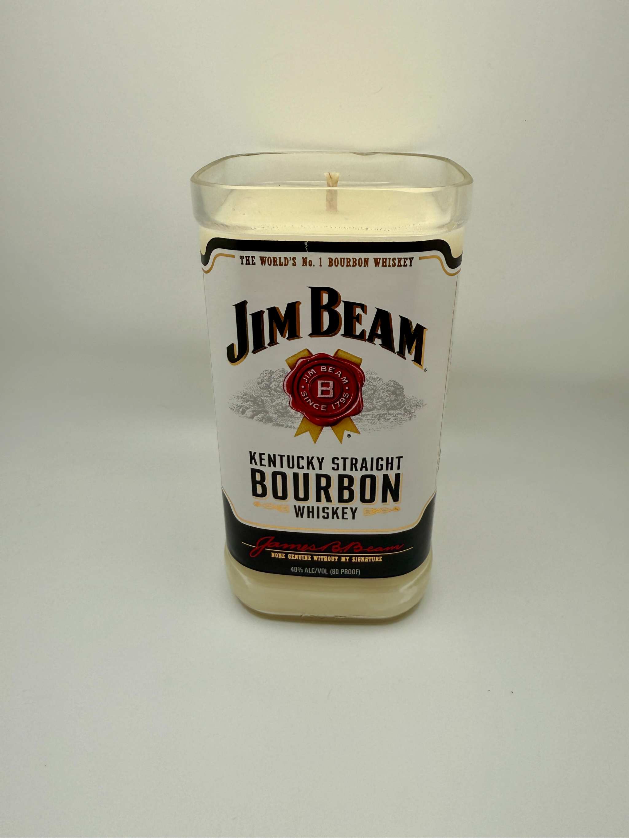 Upcycled whiskey bottle candle with Fred's Cigars fragrance in a Jim Beam bourbon bottle