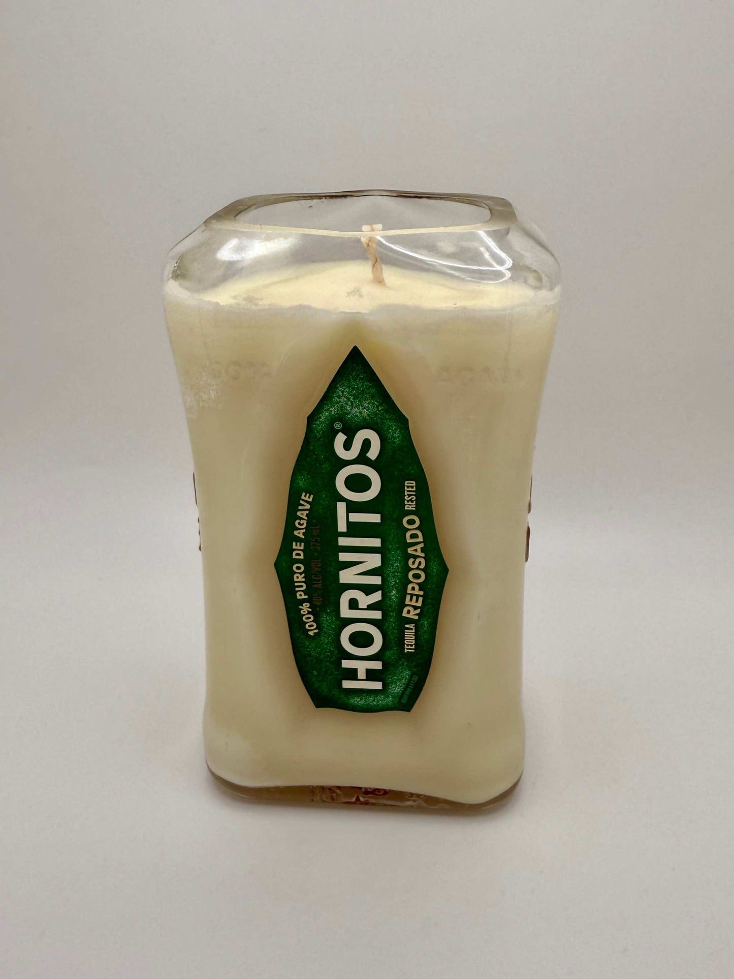 Upcycled tequila bottle candle with citron and mandarin scent in a repurposed Hornitos bottle