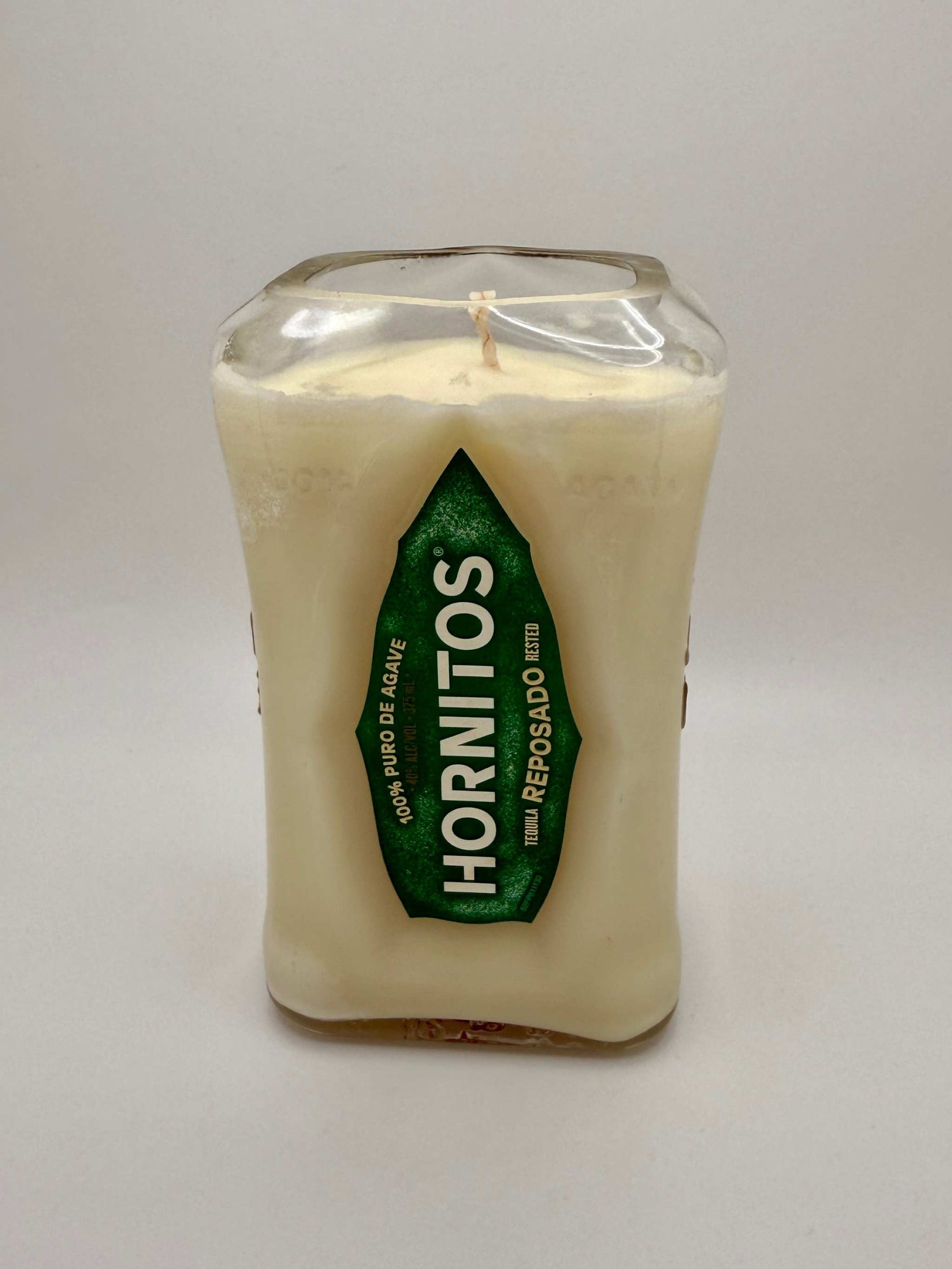 Upcycled tequila bottle candle with citron and mandarin scent in a repurposed Hornitos bottle