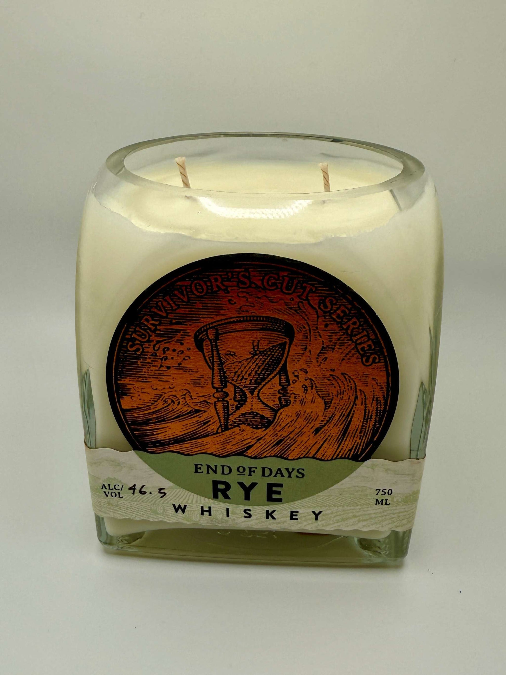 Upcycled whiskey bottle candle with Island Citrus soy wax scent and two wicks in a repurposed rye whiskey glass container