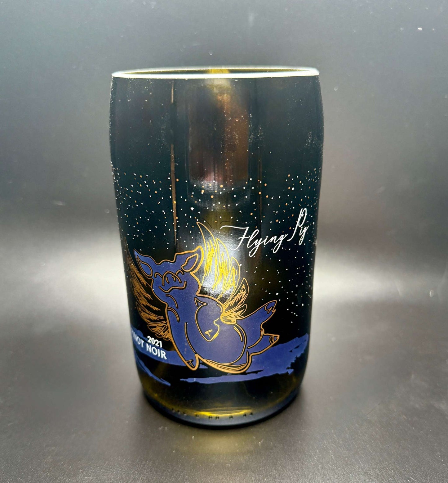 Upcycled wine bottle soy candle with flying pig design and customizable fragrance