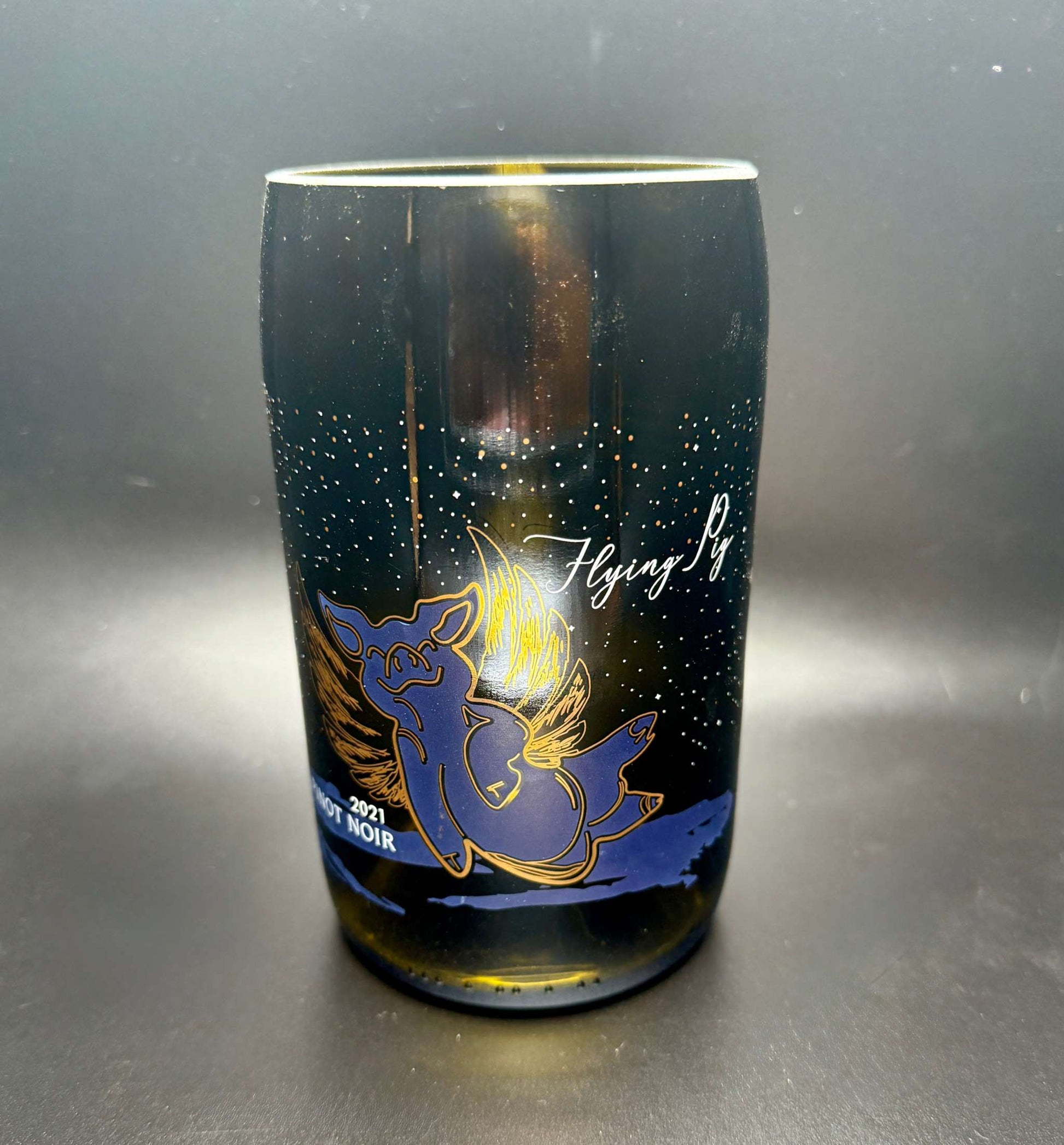 Upcycled wine bottle soy candle with flying pig design and customizable fragrance