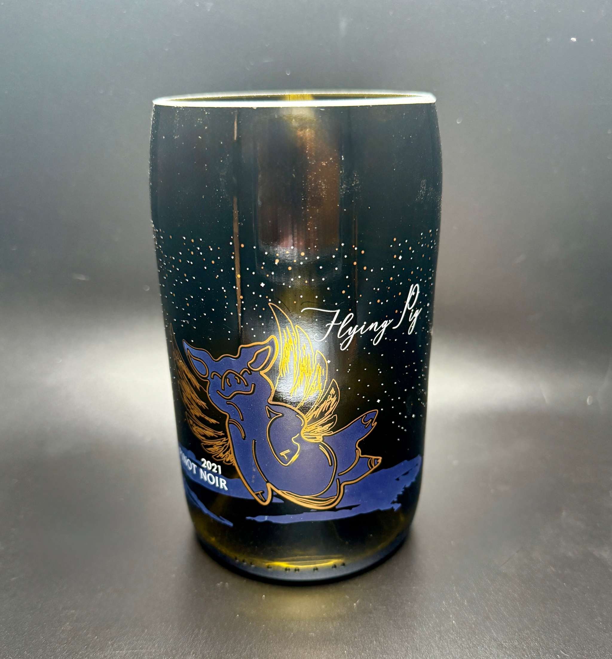 Upcycled wine bottle soy candle with flying pig design and customizable fragrance