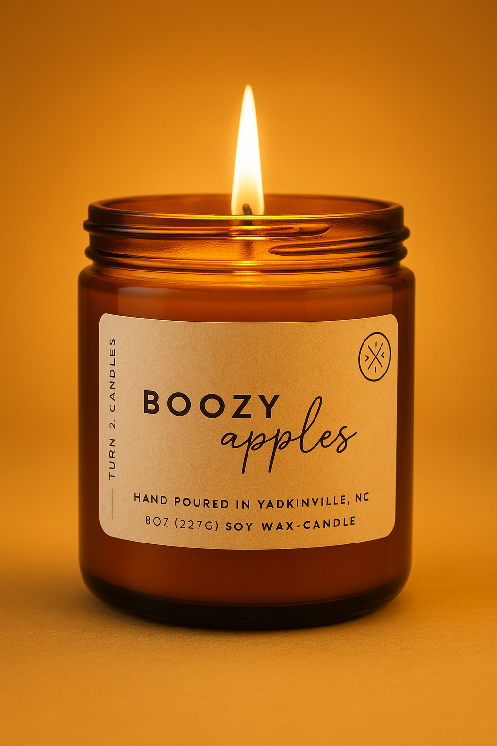 Burning amber jar candle labeled Boozy Apples, hand-poured soy wax in 8oz amber glass jar