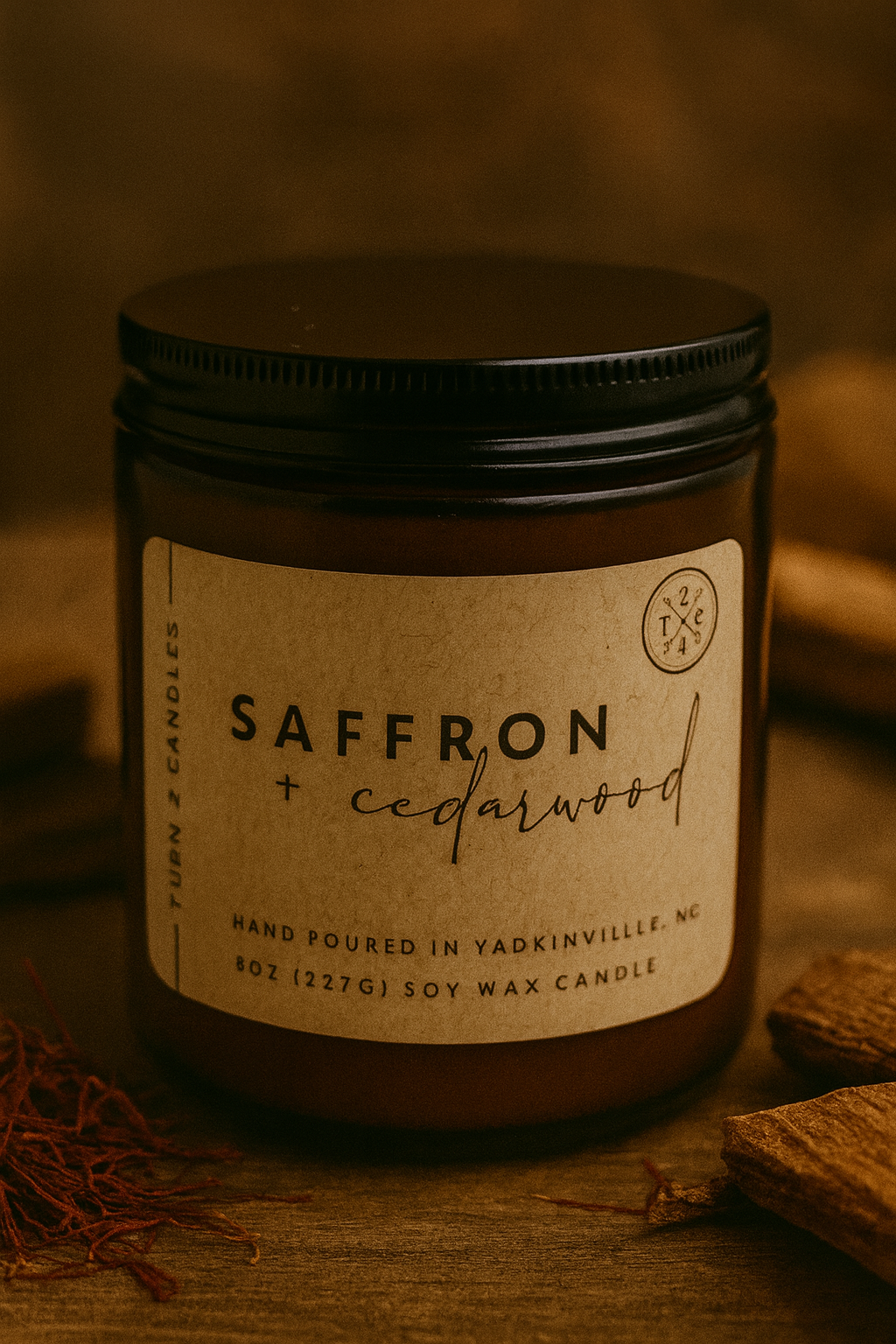 Saffron + Cedarwood candle in a brown jar with a label on a wooden surface.